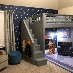 a child's bedroom with a loft bed and stars on the wall behind it