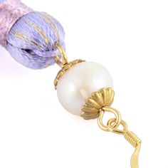 a close up of a ball of yarn and a bead on a hook chain