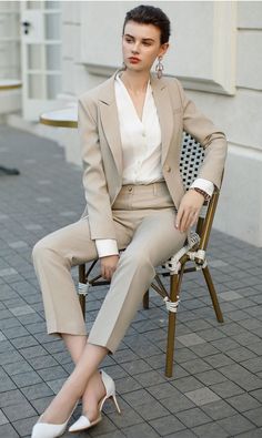 Crafted for the modern woman who appreciates finesse in simplicity, our Chic Sandstone Tailored Suit Set is the definition of workplace elegance. This set features a meticulously tailored blazer with a notched lapel and a single-button closure to enhance your silhouette. The matching trousers are cut to perfection, offering a slim fit that complements the relaxed form of the blazer. With its neutral sandstone color palette, this ensemble promises versatility and style that transitions seamlessly from boardroom to an evening out. #FashionByTeresa Description: Peak lapel; double-breasted button front. Chest welt pocket. Flap pocket detail. Straight hem. Polyester 100% Lining polyester. Imported Ankle length pant Model # CP1944 Sophisticated Blush Power Suit Embrace the allure of sophisticati Women Power Suit Business, Ladies In Suits, Brand Moodboard, Sandstone Color, Office Clothes, Modern Suits, Beige Suits, Tailored Suit