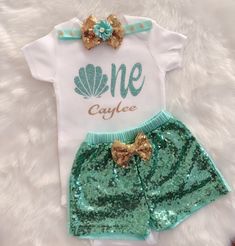 "This listing is for Under the sea inspired First Birthday outfit . Includes Bodysuit, Sequin Shorts and headband.Bodysuit used is carter's brand .It can be personalized with name Carter's Bodysuit is Crafted in babysoft cotton, Easy to change with Nickel-free snaps on reinforced panels . Perfect for first birthday/cake smash Birthday number color can be changed , please message me prior to purchasing to see if I have your color option available! To personalize your order please leave a note upo One Year Old Mermaid Birthday Outfit, Oneder The Sea 1st Birthday Outfit, Under The Sea Birthday Party Outfit, Under The Sea Birthday Shirt, Mermaid First Birthday Outfit, 1st Birthday Under The Sea Theme, Beach Theme First Birthday Party Girl, One-der The Sea Birthday, First Birthday Sea Theme