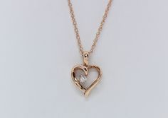 Cherish the elegance of our 14K Rose Gold Heart Pendant, gracefully adorned with .03 carats total weight of Lab Diamonds, accompanied by an 18" Chain. This exquisite piece is skillfully handcrafted by our artisanal goldsmith at Jewelry By You. Gold Heart Pendant, Heart Pendant Gold, Rose Gold Heart, Gold Heart, Lab Diamonds, Heart Pendant, Diamond Jewelry, Jewelry Necklace Pendant, Lab