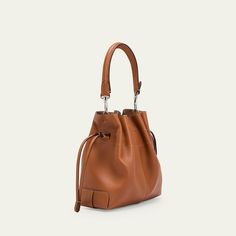 Tod's "Di" bucket bag in soft full grain leather  Detachable tubular top handle  Detachable, adjustable crossbody strap Can be worn as a top handle or crossbody bag  Drawstring closure  Distinctive Tod's logo stamped on the front Lining: Leather Approx. 6.6"H x 7.8"W x 3.9"D Made in Italy Luxury Bucket-shape Shoulder Bag For On-the-go, Leather Bucket Satchel For On-the-go, Cognac Bucket Bag For On-the-go, Cognac Bucket Bag With Handle Drop, Leather Crossbody Bucket Bag For On-the-go, Classic Leather Bucket Bag With Double Handle, Leather Bucket Bag With Detachable Handle As Shoulder Bag, Everyday Cognac Bucket Bag With Detachable Strap, Leather Hobo Bag With Bucket Shape