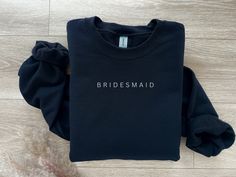 "Bridesmaid Sweatshirt, Bridesmaid, Bridal Tee, Bridesmaid Gift, Bridal Shirt, Bride Tribe Shirt, Bridal Gift, Bachelorette Gift, Wedding Gift, Bride Club, Cute Bride Apparel, Gift Idea, Minimalist Gift, Bride Life Shirt, Cute Bride Shirt, Mrs Apparel, Mrs Shirt, Mrs Sweatshirt, Wedding Gift, Wedding Merch, Bridesmaid Gift, Bride Tribe DETAILS Our sweatshirts are soft and very comfy. They do run BIG since they are unisex sizing, so please make sure to choose your size accordingly! For a more relaxed and oversized fit, we recommend sizing up. FABRIC Gildan Sweatshirt -- 8 oz., 50% Cotton/ 50% Polyester -- Preshrunk -- Ribbed Collar -- Double needle stitching throughout entire item. MATERIALS Handmade and heat pressed with quality heat transfer vinyl. PERSONALIZATION This item is offered in Bridesmaid Sweatsuit, Sweatshirt Bridesmaid, Wedding Merch, Bride Apparel, Bridal Shirt, Bride Tribe Shirt, Bridesmaid Shirt, Mrs Sweatshirt, Bridal Shirts