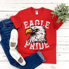 Show your love of the game with this vintage style Eagle Pride design on a super soft t-shirt. This is a fun distressed retro school spirit shirt for the games and everyday wear! It makes the perfect sports mom gift or teacher gift! This vintage school spirit tee is everything you've dreamed of and more. This vintage shirt is perfect for the season layered under your favorite cardigan! It feels soft and lightweight, with the right amount of stretch. It's comfortable and flattering for all.  Show School Athletic Shirts, Vintage Sports Shirt Design, School Spirit Shirts Designs Elementary, Elementary School Spirit Wear, School Apparel Ideas, School T-shirts, Cotton Sports Fan Shirt With Sublimation Print, School Mascot Shirts, Sports Fan Cotton Shirt With Graphic Print