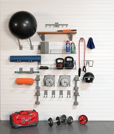 there is a gym room with equipment on the wall