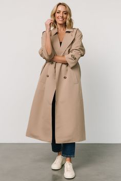 Classic trench coat for rainy or chilly days Neutral beige color Crisp Poplin fabric Notched lapel Buttoned shoulder epaulet Back storm vent Six tortoise shell colored buttons Slash pockets on front of jacket Buttoned adjustable cuff Self-tie sash Center-back vent Fully lined Self: 50% Polyester, 50% Recycled Polyester Lining: 100% Polyester Trina is 5'6, cup size 32D, size 2 and is wearing size S Trench Coat Beige, Classic Trench Coat, Neutral Beige, Cup Size, Jacket Buttons, Poplin Fabric, Tortoise Shell, Beige Color, Tortoise