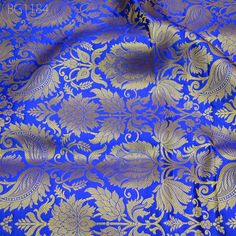 Royal Blue Brocade Banarasi Fabric by the Yard Banarasi Brocade for Wedding Dress lehenga Skirt Costume Crafting Home Decor Table Runner. This is a beautiful heavy benarse art silk brocade floral design fabric in Royal Blue and Gold.  ➤Product: Brocade Fabric ➤Fabric Type: Blended Silk (Viscose and Silk) Fine quality Zari Brocade Weaving from Banarasi ➤Color: Royal Blue and Gold ➤Width: 44 inches. ➤Condition: New ➤Code: bg1184 ➤Listing for 1 Yard of fabric. ➤Care: Dry Clean Only You can use this fabric to make Dresses, Tops, Blouses, Jackets, Crafting, Clutches or Evening Bags, Embellish your clothes, Pillows, Drapery, Home Décor, Outdoor, Quilting, Sewing, General, Upholstery etc use it for scrap booking projects. If you purchase more than 1 Yard you will get it in running length, not in Royal Traditional Wear With Pallu For Eid, Blue Lehenga With Motifs For Traditional Ceremonies, Royal Traditional Wear For Festive Ceremonies, Blue Choli With Zari Weaving For Traditional Ceremonies, Blue Katan Silk Lehenga With Motifs, Eid Blue Brocade Lehenga, Blue Brocade Lehenga For Eid, Blue Brocade Lehenga For Wedding, Blue Jamawar Lehenga For Wedding