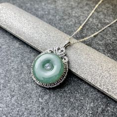 - 100% Grade A untreated natural Jadeite Jade pendant with necklace - 925 Sterling Silver Setting with CZ Crystal - 18 inches (45cm) 925 Sterling Silver chain included - Detail handcrafted and fine polished - Crafted on both sides - Every jade piece is uniquely carved and with its own special characteristic - Bring Protection, Safe and Calm - Dimension per piece: 36mm (H) x 23mm (W) x 5mm (T) - Weight: 5g each(approx.) Fine Jewelry Jade Round Pendant Necklace, Fine Jewelry Jade Necklace With Round Pendant, Silver Jade Round Necklace, Silver Round Jade Necklace, Fine Jewelry Jade Round Pendant, Jade Pendant Necklace For Anniversary, Anniversary Jade Pendant Necklace, Round Pendant Necklaces With Bail For Anniversary, White Gold Jade Round Necklace