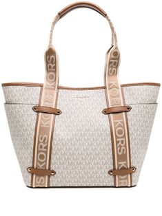 Maeve logo-strap tote bag from MICHAEL MICHAEL KORS featuring monogram pattern, gold-tone logo plaque, two logo-embellished shoulder straps, concealed magnetic fastening, internal zip-fastening pocket and light brown. | MICHAEL Michael Kors Maeve logo-strap tote bag Large Handbags Tote, Michael Kors Tote Bags, Monogram Pattern, Leather Laptop Bag, Bag Light, Chanel Deauville Tote Bag, Handbags Michael Kors, Large Tote, Michael Kors Bag