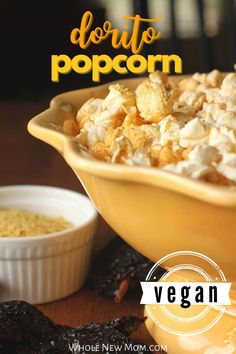 a yellow bowl filled with popcorn next to other foods