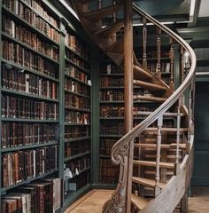 a spiral staircase in a library filled with books