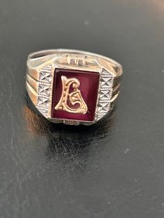 Delayed Shipping-we are away from our shop and won't be able to mail until July 8 Larry, Liam Or Linda would love this ring. Sterling and 10K gold signet/monogram set on faux red ruby backing. Lots of detail will make this a special ring for that special someone. SEE PHOTOS Ring is marked Sterling/10K and a SA incised signature  Ring size 10 1/2 - 11 Ask questions if unsure Condition is good, this is VINTAGE, used and might show wear Check our shop to see more Vintage items www.etsy.com/shop/missenpieces Signature Ring, Photo Ring, Signature Rings, 10k Gold Ring, Signet Rings, Special Ring, Letter L, Red Band, Red Ruby