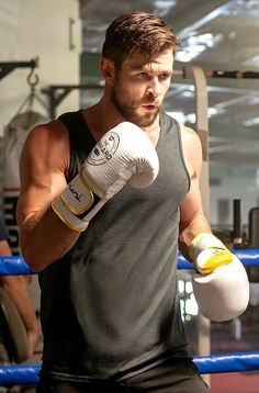 a man in black shirt and white boxing gloves