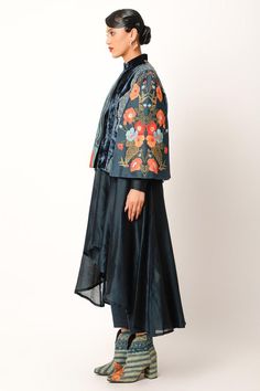 Midnight blue jacket with cape sleeves, abstract pattern patch work panels, multi color floral thread, applique and zari embroidery. Paired with flared anarkali with high-low hem and straight pant.
Components: 3
Pattern: Embroidered and Printed
Type Of Work: Applique, Thread and Zari Work
Neckline: Jacket: Band Collar
Sleeve Type: Jacket: Cape Sleeves
Fabric: Chanderi, Velvet, Cotton Slub
Color: Blue
Other Details: 
Panelled jacket
Length:
Cape: 23.5 inches
Anarkali Front: 38 inches
Anarkali Bac Festive Cape Dupatta With Resham Embroidery, Festive Cape Shape Dupatta With Resham Embroidery, Festive Cape-shaped Dupatta With Resham Embroidery, Festive Resham Embroidery Cape Dupatta, Anarkali Long Sleeve Festive Outerwear, Winter Anarkali Kurta With Resham Embroidery, Anarkali Sets With Resham Embroidery For Winter, Anarkali Kurta For Fall Festive Occasions, Festive Fall Anarkali Kurta