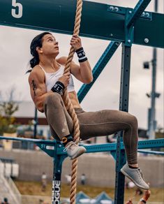 a woman hanging from a rope in the air