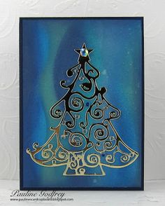 a card with a christmas tree on the front and blue background, in gold foil