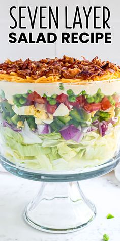 a layered salad in a glass dish with the words seven layer salad recipe above it