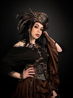 Delightful exclusive women's hat in black-bronze color with feathers decorated with a skull, bones and pendants.  It's the perfect piece to complete your costume, and guaranteed to make you feel like a pirate queen wherever you choose to wear it. Belt size 70 to 85 cm (27.5 to 33.5 inches). The headdress can be purchased separately, with a full suit, or as part of two separate sets. SET1 includes: headdress, necklace, choker and earring (clip). SET2 includes: headdress, necklace, choker and earr Cute Pirate Costume Women Plus Size, Black Steampunk Costume Accessories For Fantasy Events, Steampunk Costume Accessories For Carnival, Steampunk Costume Accessories For Fantasy Events, Gothic Headpieces For Cosplay And Festivals, Steampunk Headpiece For Halloween Cosplay, Steampunk Costume Accessories For Cosplay Events, Gothic Headpieces For Cosplay And Fantasy Events, Gothic Headpieces For Fantasy And Cosplay Events