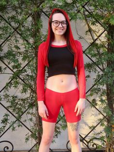 "This long sleeve black and red crop top fits soft and smooth against your body.  It is made from the popular and sporty raglan cut, and has a black body with red sleeves and collar. Worn With: Red Not So Short Mid Thigh Low Rise Shorts. The model is 5'5\" and wearing a size small. The fabric is stretchy and adjusts to the shape of your body. Although we make every effort to portray the accurate colors, colors and fit may vary slightly from the picture due to lighting and body type, as with all apparel. Size Chart (inches):                              S            M           L Bust                      27-30 31-34    34-37 Natural Waist        26            28    30 Length                        12.5             13     15  Materials:  95% rayon, 5% spandex. Custom print on this crop top: Red Stretch Long Sleeve Crop Top, Red Long Sleeve Stretch Crop Top, Fitted Red Long Sleeve Crop Top, Trendy Red Stretch Crop Top, Red Fitted Crew Neck Crop Top, Red Fitted Sporty Crop Top, Sporty Fitted Red Crop Top, Red Long Sleeve Trendy Crop Top, Sporty Red Fitted Crop Top