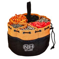 an orange and black bag filled with lots of different things on top of a white background