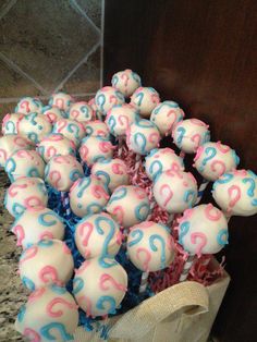 a bunch of cupcakes with question marks on them in blue and pink icing