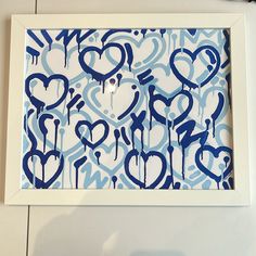 a blue and white painting with hearts on it