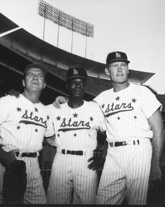 three baseball players are posing for a photo