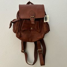 Brown Salem Mini Backpack By Overland In Cognac Leather. Nwt. Weathered Oiled Leather, Soft Slouchy Design, Zip And Snap Buckle Closure, Cotton Lining, Exterior And Interior Pockets, Adjustable Shoulder Straps. 11.70" Height, 7.50" Wide, 3" Deep, 1.75 Pounds Cognac Leather Travel Backpack With Adjustable Strap, Classic Crossbody Travel Backpack, Cognac Leather Backpack With Adjustable Strap For Travel, Classic Crossbody Backpack For Travel, Cognac Backpack With Adjustable Strap, Cognac Leather Travel Backpack, Cognac Backpack With Adjustable Strap For Travel, Cognac Leather Crossbody Backpack For Travel, Cognac Backpack With Adjustable Strap For Daily Use