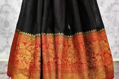 Timeless and elegant black Banarasi tussar saree for weddings, parties and festive occasions. The contrasting red zari border and pallu makes the saree absolutely classic. It comes with a matching red blouse piece. Shop online at Pure Elegance or visit our store in USA! Black Saree With Border For Puja, Festive Black Banarasi Silk Pre-draped Saree, Yellow Saree With Black Border, Black Saree Orange Border, Maroon Saree With Golden Border, Banarasi Sari, Tussar Saree, Wedding Sarees, Red Blouse