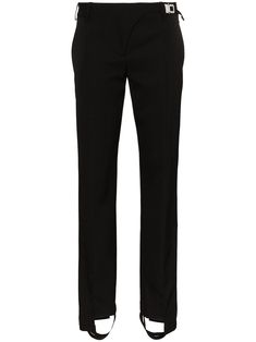 These black 1017 ALYX 9SM stirrup slim leg wool trousers are crafted in Italy and feature a straight, mid-waisted fit with stitches down the front of the legs. They close with a zipper and button concealed by an industrial buckle and strap on the side of the hip. Stirrups are not just for horse riding anymore, so you’ll want to add these 1017 ALYX 9SM pants to your non-equestrian wardrobe quickly before everyone else rides along. Sleek Straight Silhouette Pants With Pressed Crease, Sleek Straight Pants With Pressed Crease, Fitted Bottoms With Straight Silhouette For Evening, Fitted Straight Silhouette Bottoms For Evening, Fitted Straight Silhouette Evening Bottoms, Tailored Black Pants With Straight Silhouette, Tailored Black Straight Pants, Black Tailored Straight Silhouette Pants, Classic Pants With Straight Silhouette In Elastane