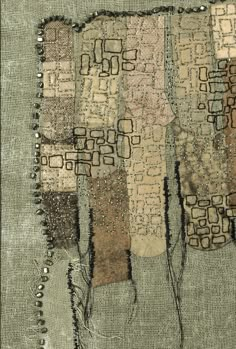 an old piece of cloth that has been stitched together with beads and threads