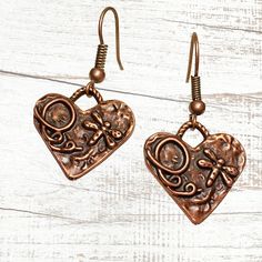 Copper Bohemian heart earrings with rustic charms. Beautifully detailed charms feature dragonflies! Lightweight earrings for casual or dressy occasions. Very pretty and versatile, these earthy minimalist earrings complement any style. Free gift packaging included, earrings are carded and in a gift bag. Customize them with your choice of hypoallergenic ear wires at checkout. To see more of my handmade Bohemian and Czech glass bead earrings, visit this link to my shop: https://www.etsy.com/shop/Je Bohemian Metal Heart Earrings As Gift, Bohemian Style Heart Earrings As A Gift, Earthy Minimalist, Copper Earrings Handmade, Glass Bead Earrings, Copper Heart, Reno Nv, Lightweight Earrings, Handmade Charms