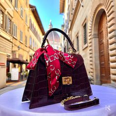 This bag has been made of the best genuine leather by local master crafters of Florence in Italy, designed for women who only accept premium Italian quality and luxury leather bags and modern Italian fashion. . Sizes: Width:   27 cm/10.75 inch Height:  19 cm/7.50 inch Depth:    9 cm/3.50 inch Color: Wine Red . The story behind this bag: It was the day of her mother's birthday, and Giulia wanted to give her something special. Her mother had always been an inspiration to her, and she wanted to express her love and gratitude through a meaningful gift. After some research, she found the perfect gift - an elegant leather bag handmade in Florence, Italy. The bag was crafted with care and precision, using only the finest Italian leather. It was a luxurious tote bag that exuded elegance and sophis Elegant Soft Leather Satchel As Gift, Luxury Red Square Satchel, Elegant Soft Leather Satchel Gift, Elegant Satchel With Leather Lining For Gift, Elegant Satchel With Leather Lining As Gift, Elegant Leather-lined Satchel For Gift, Designer Burgundy Leather Bags, Luxury Burgundy Satchel For Formal Occasions, Designer Leather Bags For Gifts