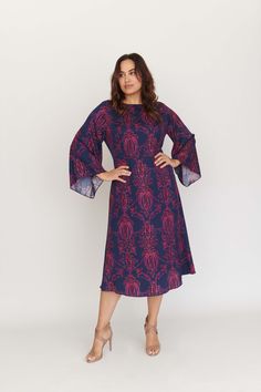 The Lucrezia Bell Sleeve Dress is as diverse as it is chic and works as well before 9 as it does after 5. Take a look at the flattering hourglass fit that truly nips the waist, and the forgiving bell sleeves that waterfall from the shoulders. If you prefer a figure-skimming look, Lucrezia has you covered. The enchanting print in shades of blueberry and blush on our silk twill call to mind sultry nights and delightful days. Let the compliments commence. Product info: 100% Silk Twill. Our model is Party Midi Dress With Blouson Sleeves, Fitted Dresses With Pleated Flutter Sleeves, Fitted Midi Dress With Flutter Sleeves For Cocktail, Fitted Midi Dress With Blouson Sleeves, Evening Dress With Blouson Sleeves, Midi Length, Blue Workwear Dress With Elastic Sleeves, Fall Cocktail Dress With Elastic Sleeves, Spring Dresses With Gathered Bell Sleeves, Fitted Midi Dress With Cape Sleeves For Spring