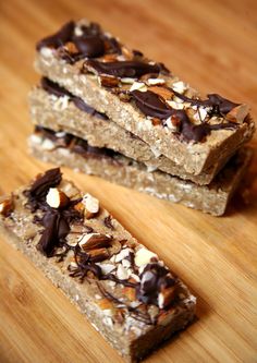 three pieces of granola bar sitting on top of a wooden table next to each other