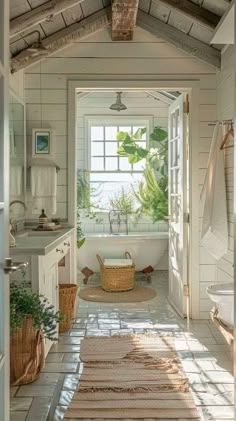 a bathroom with a tub, sink and rugs on the floor in front of it