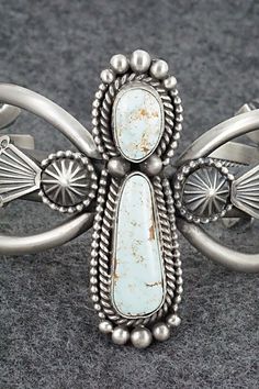 This stunning Dry Creek turquoise and sterling silver bracelet was made by Navajo silversmith Michael Calladitto. The inside is signed MC and stamped sterling.Size: 5 1/2" (will fit up to a 6 3/4" wrist)Gap: 1 1/4"Width: 2 1/8"Free shipping on all orders! We ship with USPS and always include tracking. All orders ship within a day of payment.Returns are accepted up to 30 days after you receive your order. Just send us a message. Our shop offers cash back or store credit. The item must be returned Southwestern Silver Cuff Bracelet, Collectible Southwestern Style Silver Turquoise Ring, Western Silver Bracelet With Patina, Western Style Silver Bracelet Jewelry, Western Style Silver Bracelet, Southwestern Sterling Silver Jewelry With Vintage Finish, Southwestern Silver Jewelry With Patina, Western Sterling Silver Jewelry With Patina, Silver Western Cuff Bracelet With Patina