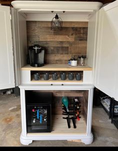 a kitchen with white cabinets and wood paneling