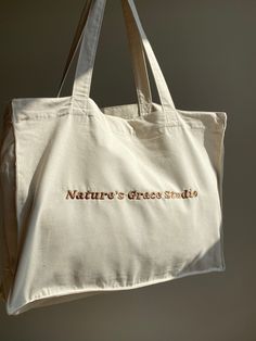 Organic Shopping tote bag Made from 100%organic cotton Luxury feel with a embroidered logo Ethically made with a transparent supply chain. For more info message me Embroidered by me :)   Washing Instructions: Washing: 30o. Bleaching no. Ironing 110o. Everyday Tote Shoulder Bag With Embroidered Logo, Cotton Shoulder Bag With Embroidered Logo For Shopping, Eco-friendly Embroidered Cotton Bags, Embroidered Cotton Eco-friendly Bags, Travel Cotton Bag With Embroidered Logo, Travel Bag With Embroidered Logo In Cotton, Cotton Tote Shoulder Bag With Embroidered Logo, Eco-friendly Embroidered Canvas Bag For Daily Use, Eco-friendly Embroidered Cotton Canvas Bag