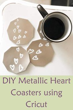 some metal heart coasters sitting on top of a white tray with coffee in it