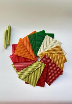 several different colored pieces of cloth next to each other on a white surface with scissors