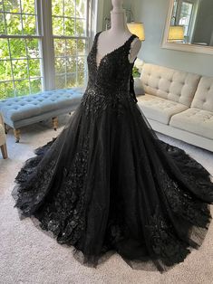 This gorgeous Custom Black Wedding Dress with a deep V neckline includes layers of tulle including bling, beautifully dispersed delicate lace all over the bodice and the skirt and a lace-up back for a timeless bridal look. This is the perfect Black Wedding Gown for your unique day! It also has pockets and can be custom made in any size and color preferences.

Follow @bridesandtailor on Instagram for our most recent designs!

If you have a custom wedding dress on your mind, send us what you have Black Wedding Dress Ballgown, Gothic Wedding Dress Black, Wedding Dress Gothic, Wedding Dress Ballgown, Wedding Ballgown, Black Lace Wedding Dress, Black Wedding Dress Gothic, Ballgown Dress, Black Lace Wedding