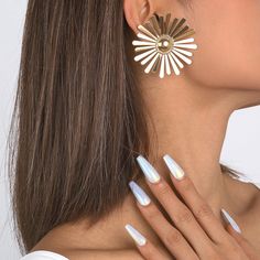 Slip on this pair of earrings featuring a bold sunflower shape in 18k gold-plated metal. 2.2" diameter 18k gold-plated copper Retro Earring, Sunflower, 18k Gold, Gold Tones, Gold Plate, Copper, Plating, Slip On, Stud Earrings