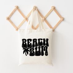 Looking for a cute tote bag to carry all your essentials this summer? This cute Beach Bum Palm Tree bag will be perfect to add to your collection. Perfect for a day at the beach or every day life! Beachy Weekend Tote Bag, Casual Canvas Bag With Letter Print For Vacation, Casual Letter Print Canvas Bag For Vacation, Summer Vacation Bag With Letter Print, Vacation Tote Shoulder Bag With Letter Print, Trendy Canvas Bag With Letter Print For Vacation, Trendy Letter Print Canvas Bag For Vacation, Fun White Beach Bag For Vacation, Fun White Beach Bag