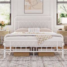 a white bed sitting in a bedroom on top of a rug