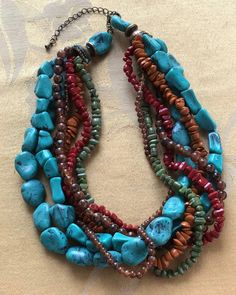 "Pretty and colorful is this faux stone (plastic) beaded multi-strand necklace . The beads are turquoise, brown, orange and green in color. It is adjustable and measures from 16\"-19\". The necklace is in very good vintage condition. The end caps and clasp are brass tone." Adjustable Multicolor Beaded Turquoise Necklace, Adjustable Multi-strand Turquoise Necklace With Colorful Beads, Adjustable Beaded Multicolor Turquoise Necklace, Multicolor Beaded Turquoise Necklace For Jewelry Making, Multicolor Beaded Southwestern Turquoise Necklace, Southwestern Style Multicolor Multi-strand Beaded Necklaces, Handmade Multicolor Multi-strand Turquoise Necklace, Multi-strand Turquoise Necklace With Large Beads, Multicolor Turquoise Necklace With Natural Stones And Round Beads