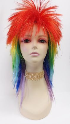 Rock out with this awesome costume wig!  Color: Rainbow and Golden Tinsel (Rainbow/TSL) Style: 15 inches, Long Layered, Spikey Circumference: Default at 21" with adjustable cap (max 22") All sales are final. Please read all store policies before purchasing. Rainbow Mullet, Wigs Rainbow, Clown Drag, Clown Wig, Mullet Wig, Outfit Planning, Edgar Allen, Scary Funny, Wig Color