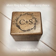 a wooden music box with the word c & s on it