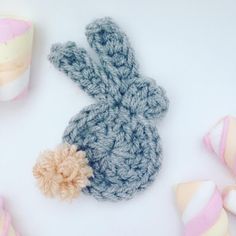 a crocheted bunny sitting next to some candy