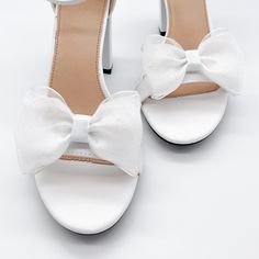 "Triple layered organza shoe clips can be worn on the front, back or side of most shoes. Listing is for one pair. Shoes not included. *Bows need to be fluffed upon arrival. - 1 pair - 3/12\" wide - Made in the USA. SHOP MORE SHOE CLIPS, https://www.etsy.com/shop/melissavelia?section_id=24145024 *Although clips are gentle and cushioned, each shoe fabric is different. Please test out the clips on your shoes before leaving them on for a long period of time. We are not responsible for any indentatio Elegant Wedding Sandals With Bow, Elegant Wedding Sandals With Satin Bow, Elegant White Sandals With Satin Bow, White Sandals With Satin Bow And Ankle Strap, White Sandals With Satin Bow Ankle Strap, White Block Heel Wedding Shoes With Bow, White Wedding Shoes With Bow And Block Heel, Elegant Spring Wedding Shoes With Ribbon, Elegant Ribbon Heels For Weddings